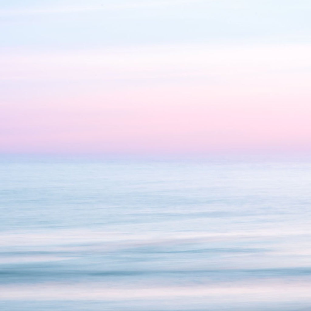 calm ocean water, pink purple sky