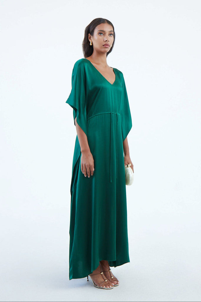 long emerald green silk kaftan dress with waist tie and wide draped elbow-length sleeves cascading down to hem