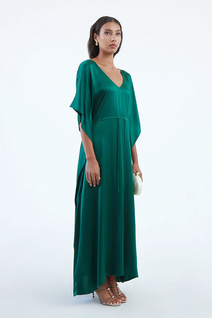 long emerald green silk kaftan dress with waist tie and wide draped elbow-length sleeves cascading down to hem