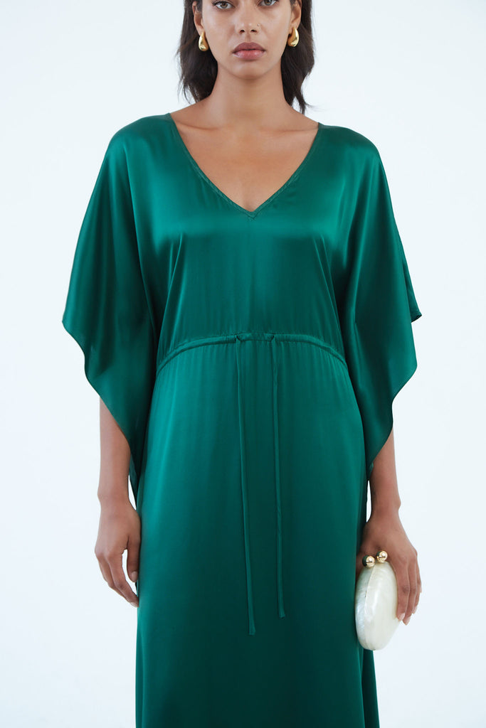 long emerald green silk kaftan dress with wide draped elbow-length sleeves, waist tie, and  low V neck