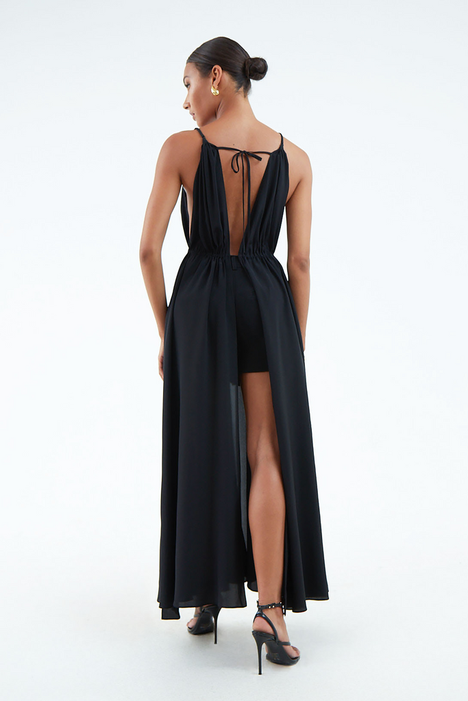 back view of long black silk dress open top to bottom, tied at waist and shoulder blades with string.