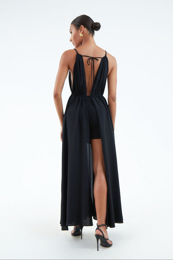 back view of long black silk dress open top to bottom, tied at waist and shoulder blades with string.