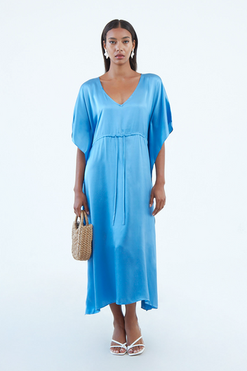 long indigo blue silk caftan dress with plunging V neck, waist tie, and wide elbow-length sleeves, continuous to hem