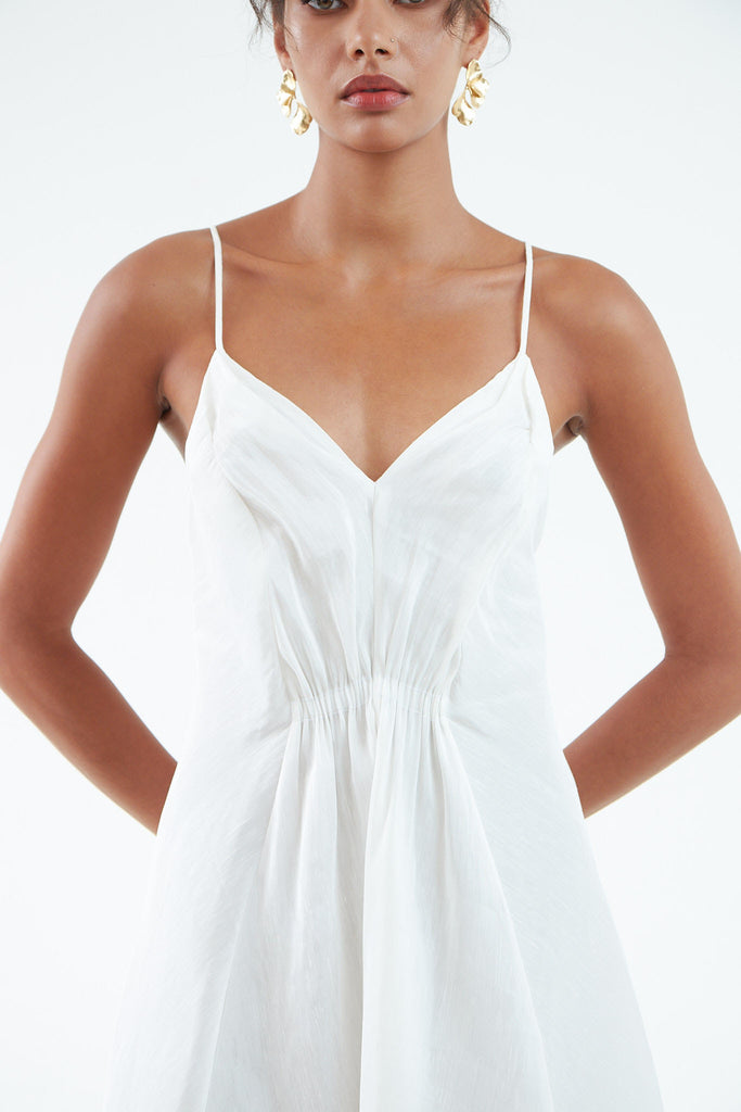 white hemp silk dress with thin shoulder straps, waist gather, and short front, long back flare. 