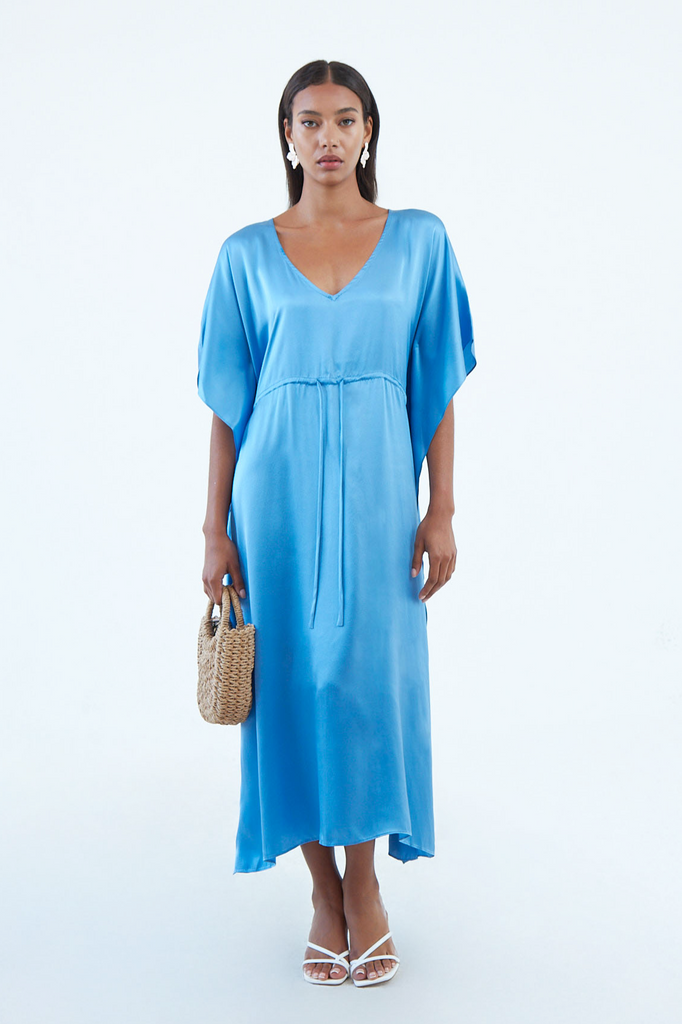long indigo blue silk caftan dress with plunging V neck, waist tie, and wide elbow-length sleeves, continuous to hem