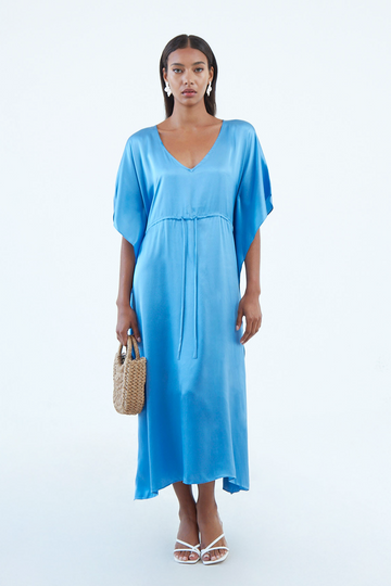 long indigo blue silk caftan dress with plunging V neck, waist tie, and wide elbow-length sleeves, continuous to hem