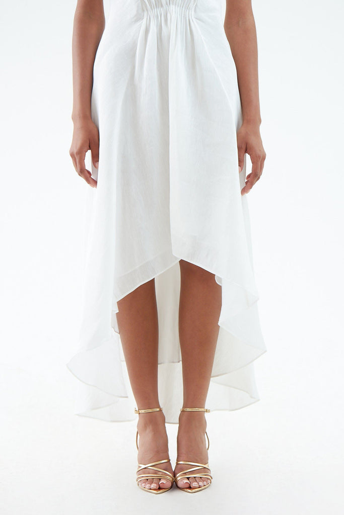 luxurious white hemp silk dress with thin shoulder straps, waist gather, flared hem that is short in front and long in back. 