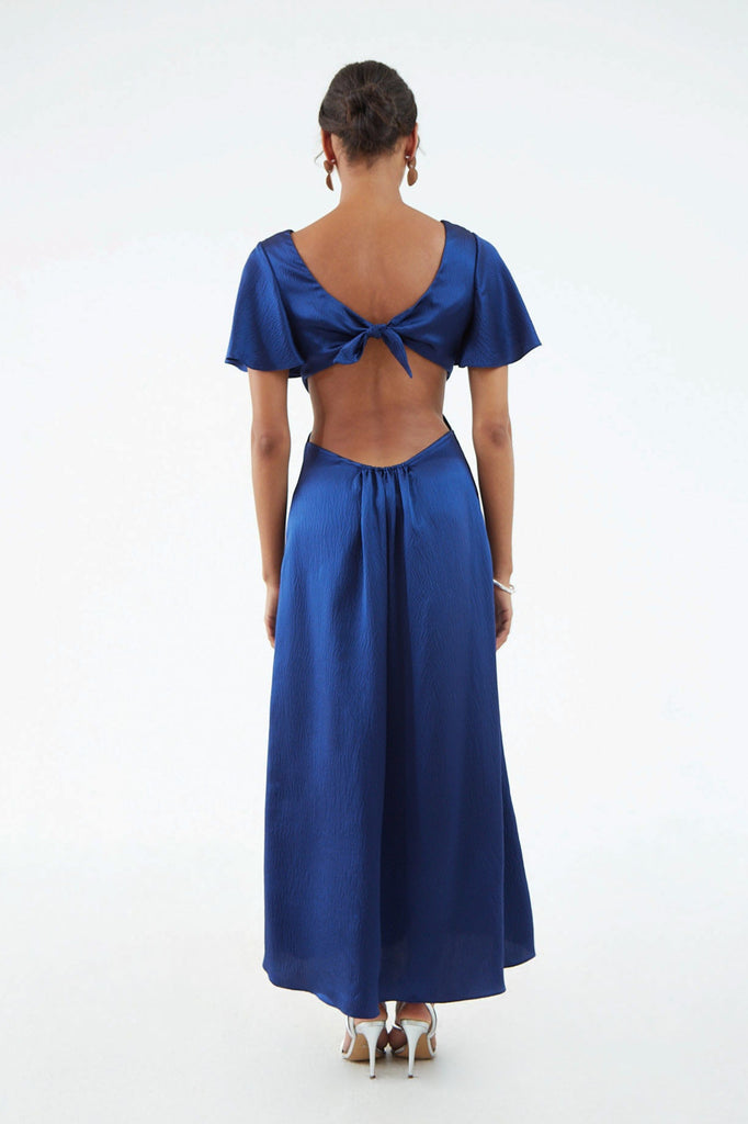 Back view of maxi navy blue hammered silk dress, short ruffle sleeves, open back with edge elastic and back shoulder tie 