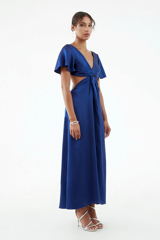 Side view of long royal blue hammered silk dress, subtle shine, front center twist with exposed waist side, flared short sleeves. 