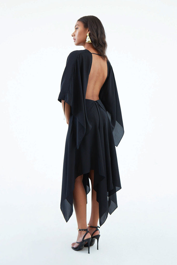 low back black silk bohemian dress with back strap, scrunched ruffle sleeves, and asymmetrical hem.
