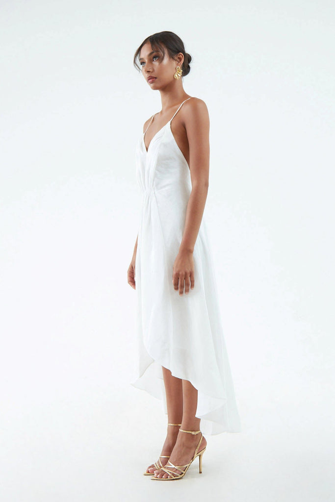 white hemp silk dress with subtle shine, thin shoulder straps, waist gather, and flared hem that's short in front and long in back
