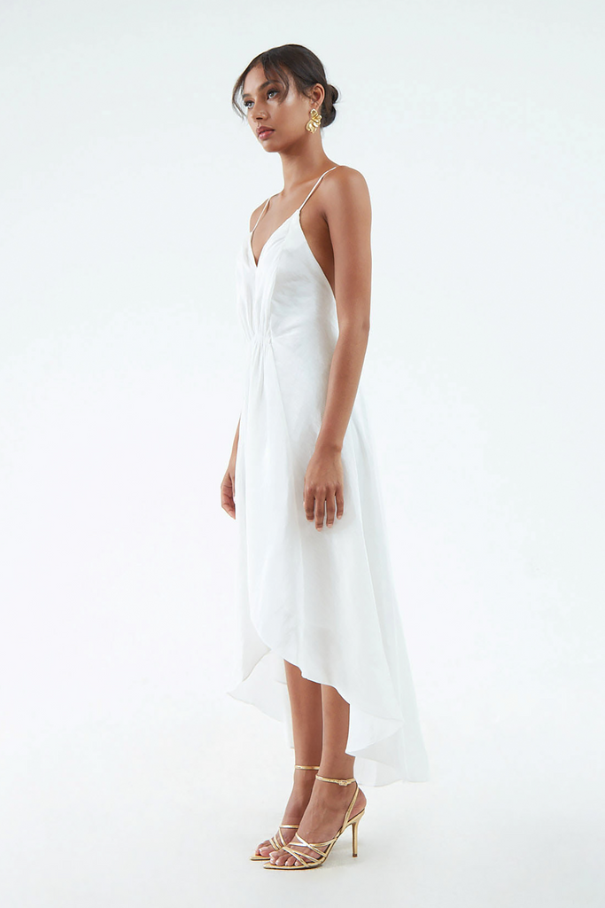 white hemp silk dress with subtle shine, thin shoulder straps, waist gather, and flared hem that's short in front and long in back